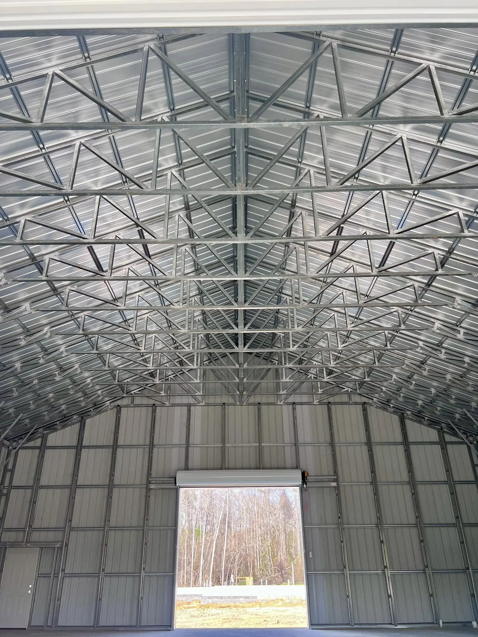 Interior roof trusses and wall panels of a steel building
