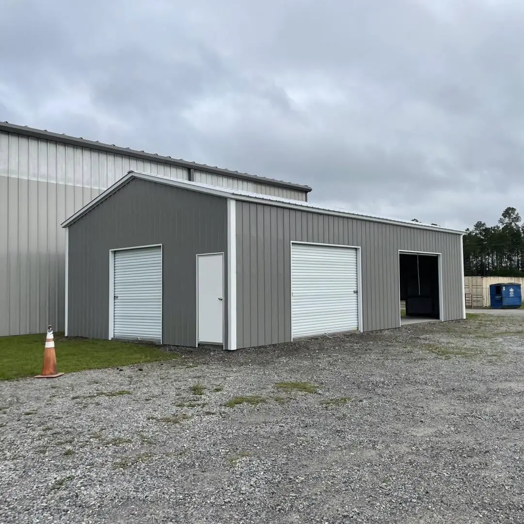 Gray steel garage with white trim and multiple vehicle entrances