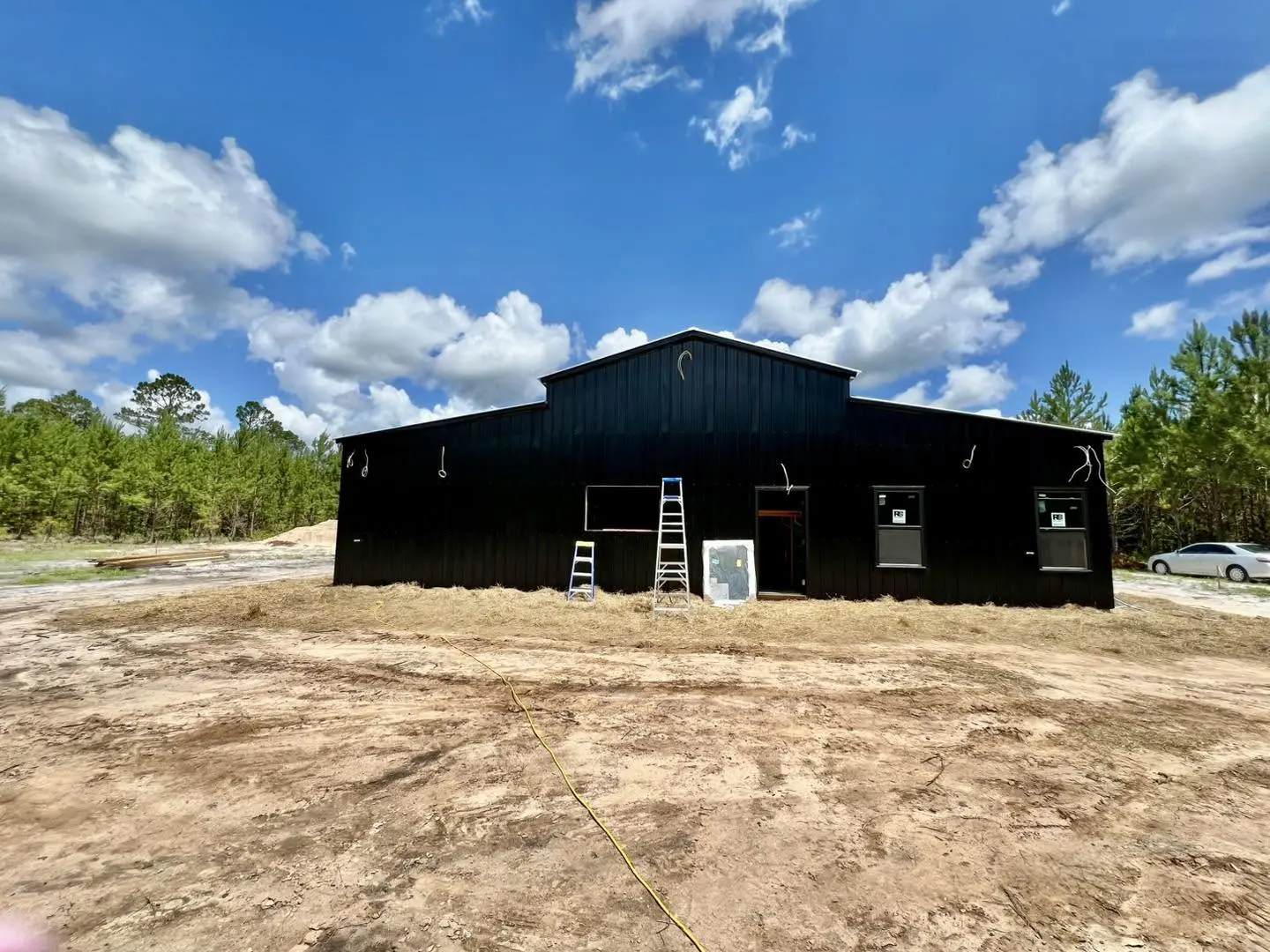 Black steel building with windows during finishing work