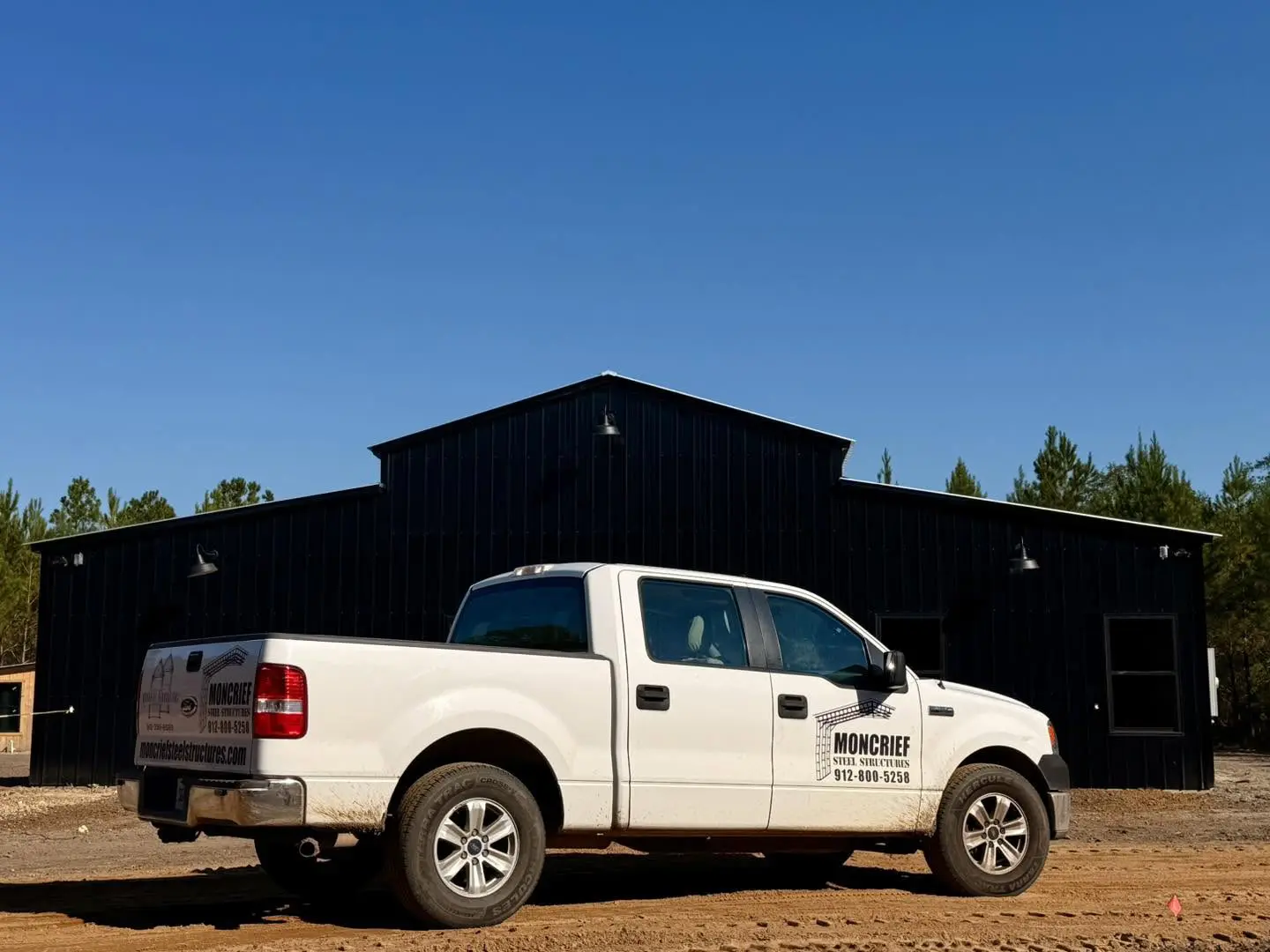 Moncrief Steel Structures truck outside a black steel building