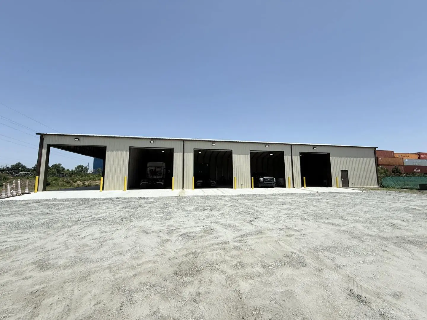 Completed commercial steel building with five large vehicle bays
