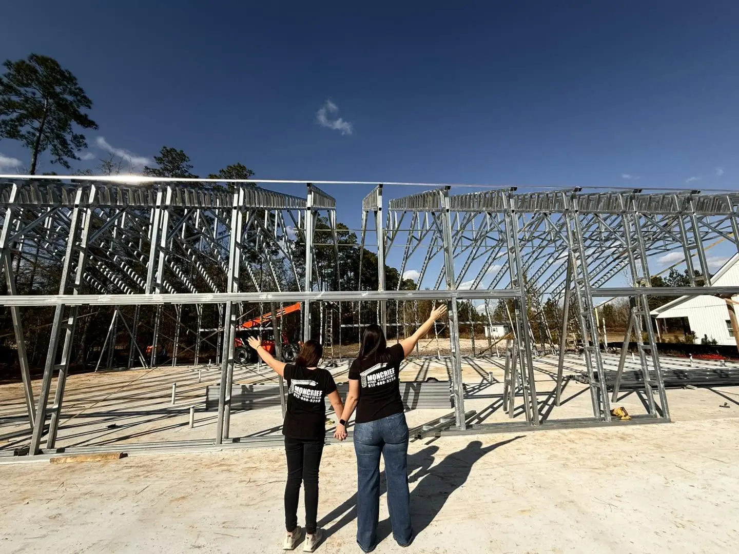 Two Moncrief team members at a steel framing installation
